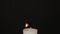 White single Candle flickering in the dark. Side view. White candle burning on the dark background. Slow motion full HD