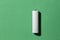 White size AA batteries on a green background top view