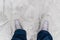 White skates on the legs of a woman on snowy ice. Winter sports. Soft focus