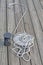 White skein rope heap closeup on vintage wooden surface deck board, pier environment,