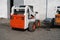 White skid steer loader at a construction site waiting of work. Industrial machinery. Industry.