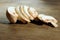 White sliced champignons on a brown wooden table. Mushrooms on wooden background.