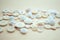 White small buttons on light wooden background