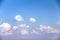 White small clouds on vast bright blue sky background with light wind