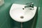 White small washbasin in small bathroom, ceramic sink with mixer