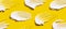White smears of foam on yellow background pattern. Horizontal banner. Beauty macro Cosmetic