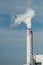 white smoke of chemical factory chimney on blue sky background