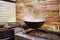 White smoke from glutinous rice steaming in countryside kitchen