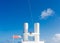 White Smokestacks Under Blue Sky