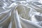 White smooth satin or silk texture background. White fabric abstract texture. Luxury satin cloth. Silky and wavy folds of silk