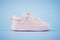 A white sneaker on a blue background. 3d render