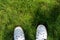 White Sneakers on a Green Grass Top View