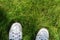 White Sneakers on a Green Grass Top View