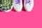 White sneakers with purple laces on bold pink