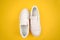 White sneakers, shoelaces, yellow background