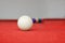 White snooker ball on red snooker table