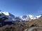 White snow mountains winding road in bright sunny day