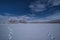 White snow plain and forest, rural road in northern Finland in winter