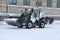 White Snow Removal Tractor in City