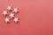 White snowflake stars on red coral background