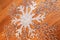 white snowflake symbol on wooden background