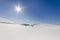 White snowy fields under a blue sky