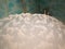 White soap foam with fancy patterns and bursting bubbles