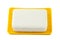 White soap on yellow holder isolated on white background