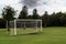 White soccer of football goal post on a grass field of a training ground