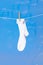 White sock on washing line with bubbles on blue background