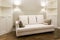 White sofa in a new, bright living room after repair. Laconic interior design