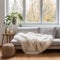 White sofa with wool blanket and fur pillow on rug against of grid window. Houseplants on wooden floor. Scandinavian interior