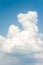 White soft cumulus congestus clouds on blue sky background.