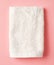 White spa towel on pink,from above