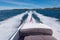 White speed boat racing across a fjord on a sunny summer day