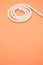 White spiral-shaped rope on  peach background