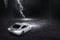 The white sports car that focuses on the back, runs on a road with rain and lightning at night