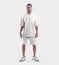 White sportswear mockup, oversized t-shirt, shorts on a guy with a beard, in sneakers, empty clothes for design, front view
