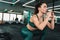 White sportswoman doing exercise while working out in gym