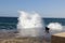 White spray against a blue sea at the port, Valletta, Malta