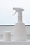 White spray bottle for liquid disinfectants for cleaning and prevention against viral infection COVID-19. Plastic packaging and co