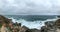 White spray, rocky coast, white clouds