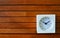 White square clock on wooden slat board