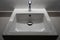 White, square countertop washbasin with chrome faucet front and top view