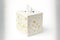 white square tissue box with flower pattern and white napkin