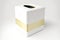 white square tissue box with gold stripe on white background