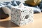 white square tissue box with textured pattern of sea pebbles