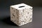 white square tissue box with textured pattern of sea pebbles