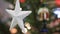 White Star on a Christmas Tree With Blurred Background. Christmas Tree With Defocused Blurred Lights Bokeh.