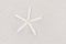 White starfish on sand, space for text